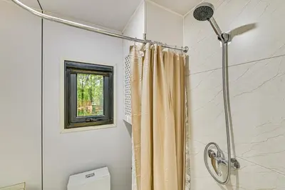 a shower with a shower curtain in a bathroom at Waterfront Durham Getaway with Deck and Trails! in East Durham