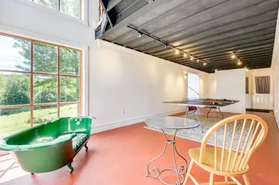 a room with a bath tub and a table and chairs at 10 Mi to Mt Snow! Grand Estate Built to Entertain in Wilmington