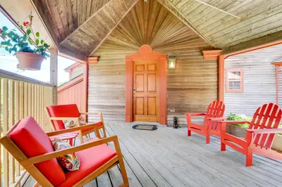 a porch with red chairs and a wooden door at 10 Mi to Mt Snow! Grand Estate Built to Entertain in Wilmington