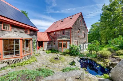 an old barn with a red roof and a pond at 10 Mi to Mt Snow! Grand Estate Built to Entertain in Wilmington