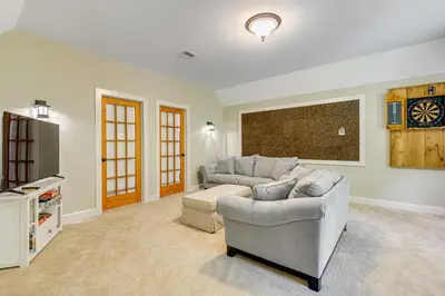 a living room with a couch and a tv at 6 Mi to Mt Snow Grand Summit Resort Spacious Home in Wilmington