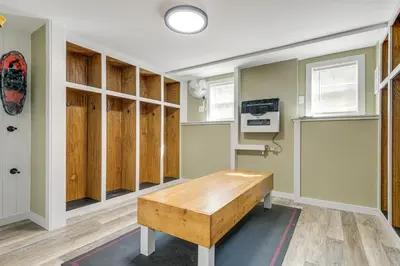 a room with wooden cabinets and a wooden table at 6 Mi to Mt Snow Grand Summit Resort Spacious Home in Wilmington