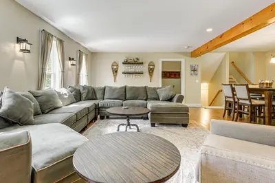 a living room with a couch and a table at 6 Mi to Mt Snow Grand Summit Resort Spacious Home in Wilmington