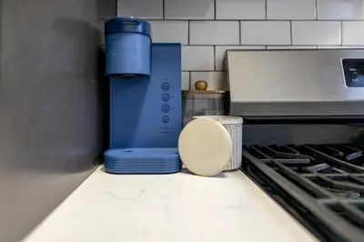a blue blender sitting on a counter next to a stove at Three BR near Metlife with Laundry & Parking in Lodi