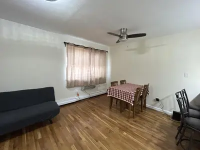 a living room with a table and a couch at NYC Bayside LIRR Cozy Suite in Bayside