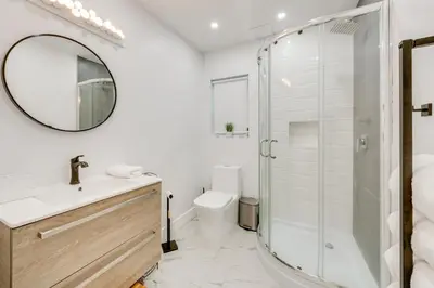 a bathroom with a shower and a sink and a mirror at Private Yard, Playset Family Home in Penn Estates in East Stroudsburg