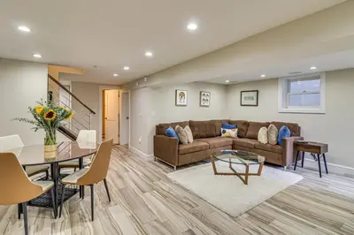 a living room with a couch and a table at Walk to Hudson River Parks Recently Renovated Apt in Hoboken