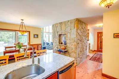 a kitchen with a sink and a stone wall at Game Room, Hot Tub! Year-Round Dover Retreat in West Dover