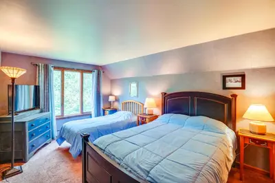 a bedroom with two beds and a television in it at Game Room, Hot Tub! Year-Round Dover Retreat in West Dover