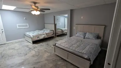a bedroom with two beds and a ceiling fan at 2 bedrooms with movie theater in Agawam