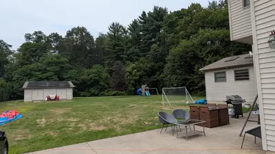 a backyard with a soccer field at 2 bedrooms with movie theater in Agawam