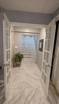 a hallway with a tile floor with a potted plant at 2 bedrooms with movie theater in Agawam
