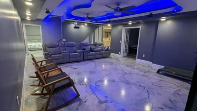a living room with couches and a blue ceiling at 2 bedrooms with movie theater in Agawam