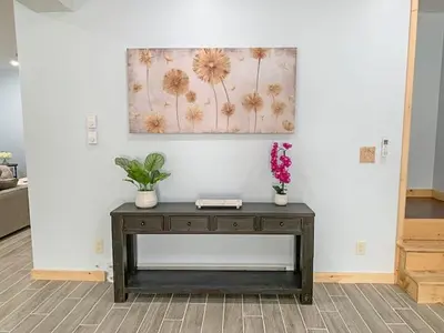 a table in a room with flowers on the wall at Luxury Log Cabin Lakefront, Game room & Fire Pit, in Schenevus