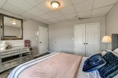 a bedroom with a large bed and a mirror at Pet-Friendly Catskills Home with Serene Pond! in Jefferson