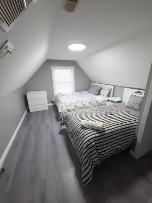 a bedroom with a bed in a attic at Grand Central & Times Square in 25-30 mins!! in Corona