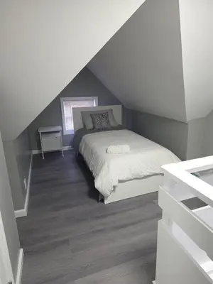 a bedroom with a bed in a attic at Grand Central & Times Square in 25-30 mins!! in Corona