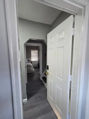 a hallway with a white door leading to a bedroom at Grand Central & Times Square in 25-30 mins!! in Corona
