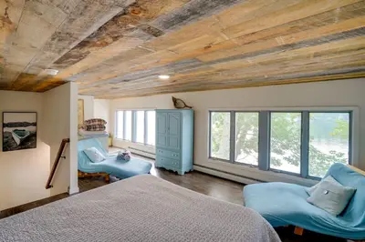 a bedroom with a bed and two chairs at Ski, Skate and Explore Ultimate Winter Getaway! in Averill Park