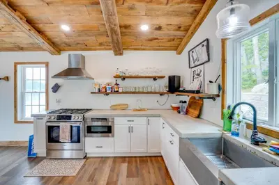 a kitchen with white cabinets and a wooden ceiling at Ski, Skate and Explore Ultimate Winter Getaway! in Averill Park