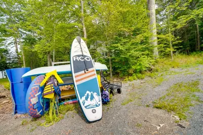 a surfboard is sitting next to a tent at Ski, Skate and Explore Ultimate Winter Getaway! in Averill Park