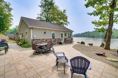 a patio with chairs and a table and a house at Ski, Skate and Explore Ultimate Winter Getaway! in Averill Park