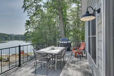 a balcony with a table and chairs and a grill at Ski, Skate and Get Cozy Fireside Crooked Lake Home in Averill Park
