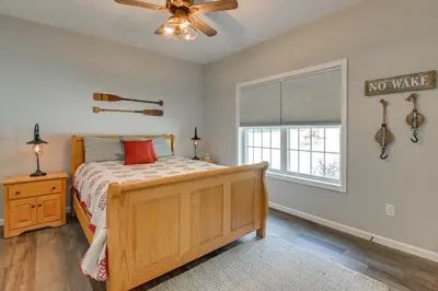a bedroom with a bed and a ceiling fan at Ski, Skate and Get Cozy Fireside Crooked Lake Home in Averill Park