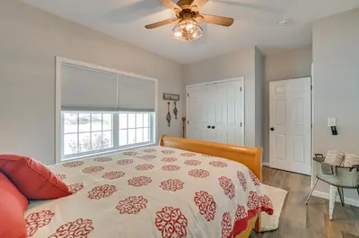 a bedroom with a bed and a ceiling fan at Ski, Skate and Get Cozy Fireside Crooked Lake Home in Averill Park