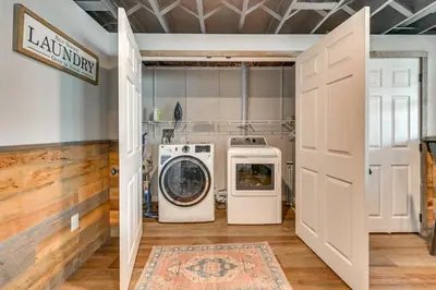 a laundry room with two washing machines in it at Ski, Skate and Get Cozy Fireside Crooked Lake Home in Averill Park