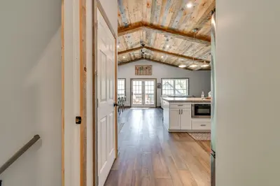 a kitchen with white cabinets and a wooden ceiling at Ski, Skate and Get Cozy Fireside Crooked Lake Home in Averill Park