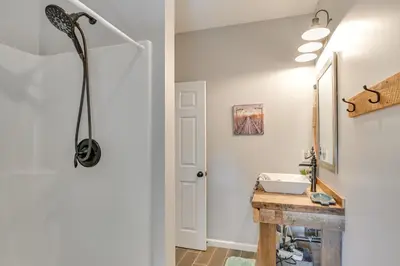 a bathroom with a sink and a mirror at Ski, Skate and Get Cozy Fireside Crooked Lake Home in Averill Park