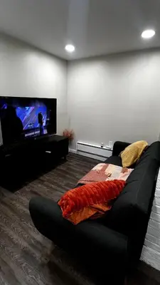 a living room with a couch and a flat screen tv at Cozy Garden 1Bed Apt, Lincoln Park in Jersey City