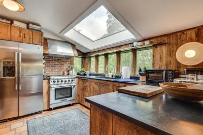 a large kitchen with a large skylight at 15 Mi to Long Island Sound Bedford Winter Retreat in Bedford
