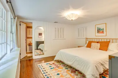 a bedroom with a white bed and a large window at 15 Mi to Long Island Sound Bedford Winter Retreat in Bedford