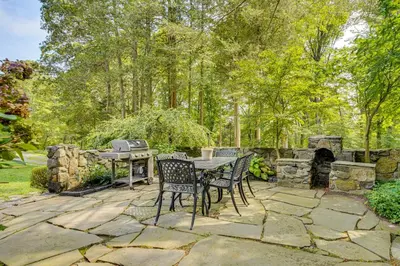 a patio with a table and chairs and a grill at 15 Mi to Long Island Sound Bedford Winter Retreat in Bedford