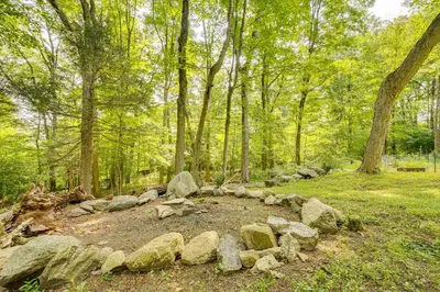 a pile of rocks in the middle of a forest at 15 Mi to Long Island Sound Bedford Winter Retreat in Bedford