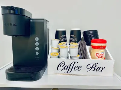 a coffee bar sitting on a shelf next to a coffee maker at Bright, Stylish and Comfy Luxury Room With Workspace! in Haledon