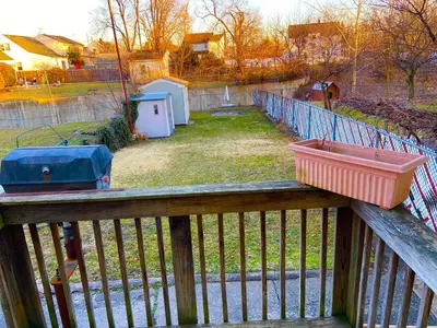 a wooden fence with two containers on top of it at Bright, Stylish and Comfortable Room with Workspace! in Haledon