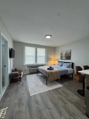 a bedroom with a bed and a table and chairs at Yale Casa Blanco in New Haven