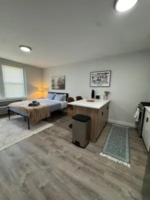 a bedroom with a bed and a desk at Yale Casa Blanco in New Haven