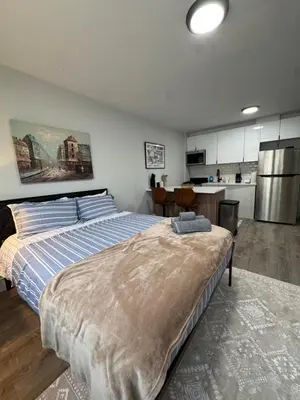 a large bedroom with a bed and a kitchen at Yale Casa Blanco in New Haven