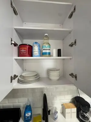 a kitchen with plates and dishes on shelves at Yale Casa Blanco in New Haven