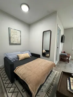 a bedroom with a bed and a large mirror at Yale Casa Blanco in New Haven
