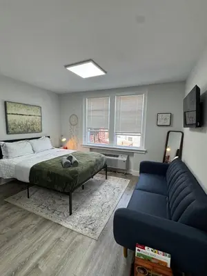 a bedroom with a bed and a couch at Yale Casa Baya in New Haven