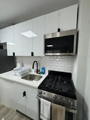 a kitchen with a stove top and a sink at Yale Casa Baya in New Haven