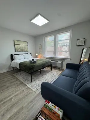 a living room with a bed and a couch at Yale Casa Baya in New Haven