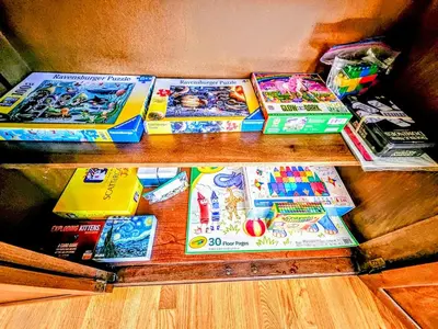 a bunch of books sitting on top of a table at 3 Bed 2 Bath, Near UAlbany & MVP Arena, Private Driveway Parking in Albany