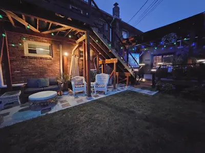 a patio with chairs and a table and a train at 3 Bed 2 Bath, Near UAlbany & MVP Arena, Private Driveway Parking in Albany