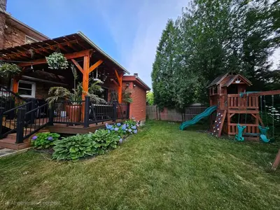 a backyard with a playground and a house at 3 Bed 2 Bath, Near UAlbany & MVP Arena, Private Driveway Parking in Albany
